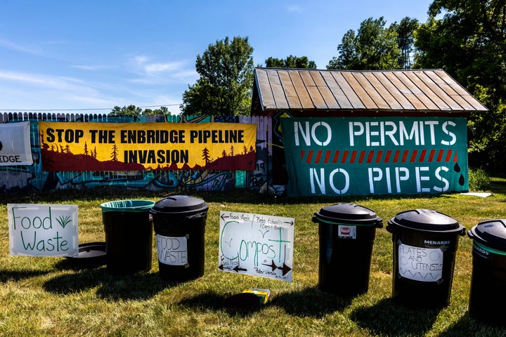 Pipeline protest signs form a backdrop to waste segregation bins at a campsite on the White Earth Nation Reservation near Waubun, Minnesota, on June 5.