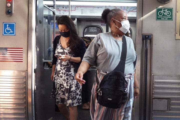 Chicago commuters wear face masks on July 27, 2021. The Centers for Disease Control and Prevention recommends that fully vaccinated people wear face masks indoors again in places with high COVID-19 transmission rates.