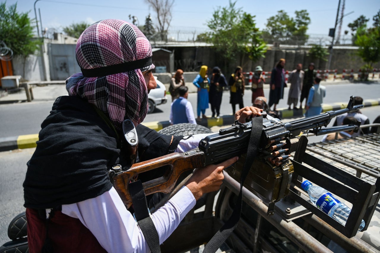 A Taliban fighter mans a machinegun on top of a vehicle as they patrol along a street in Kabul on August 16, 2021