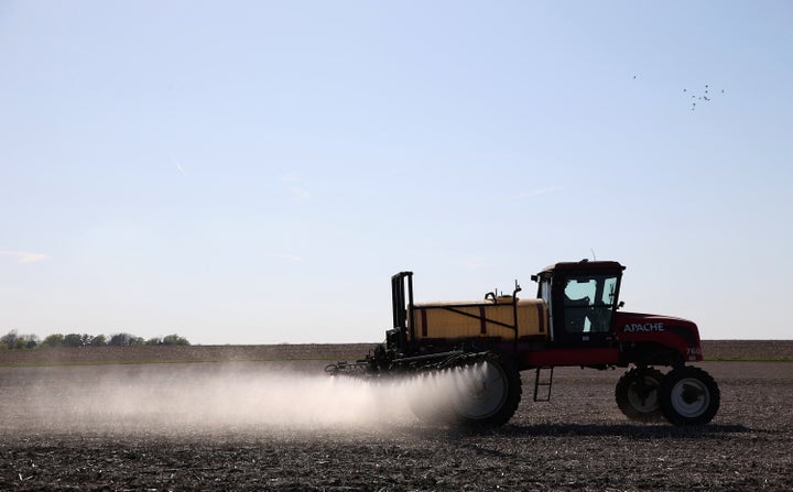 A farmer applies pesticides to a field in Hastings, Iowa, in 2015. The Biden administration said Wednesday it will ban the use of chlorpyrifos, an insecticide.