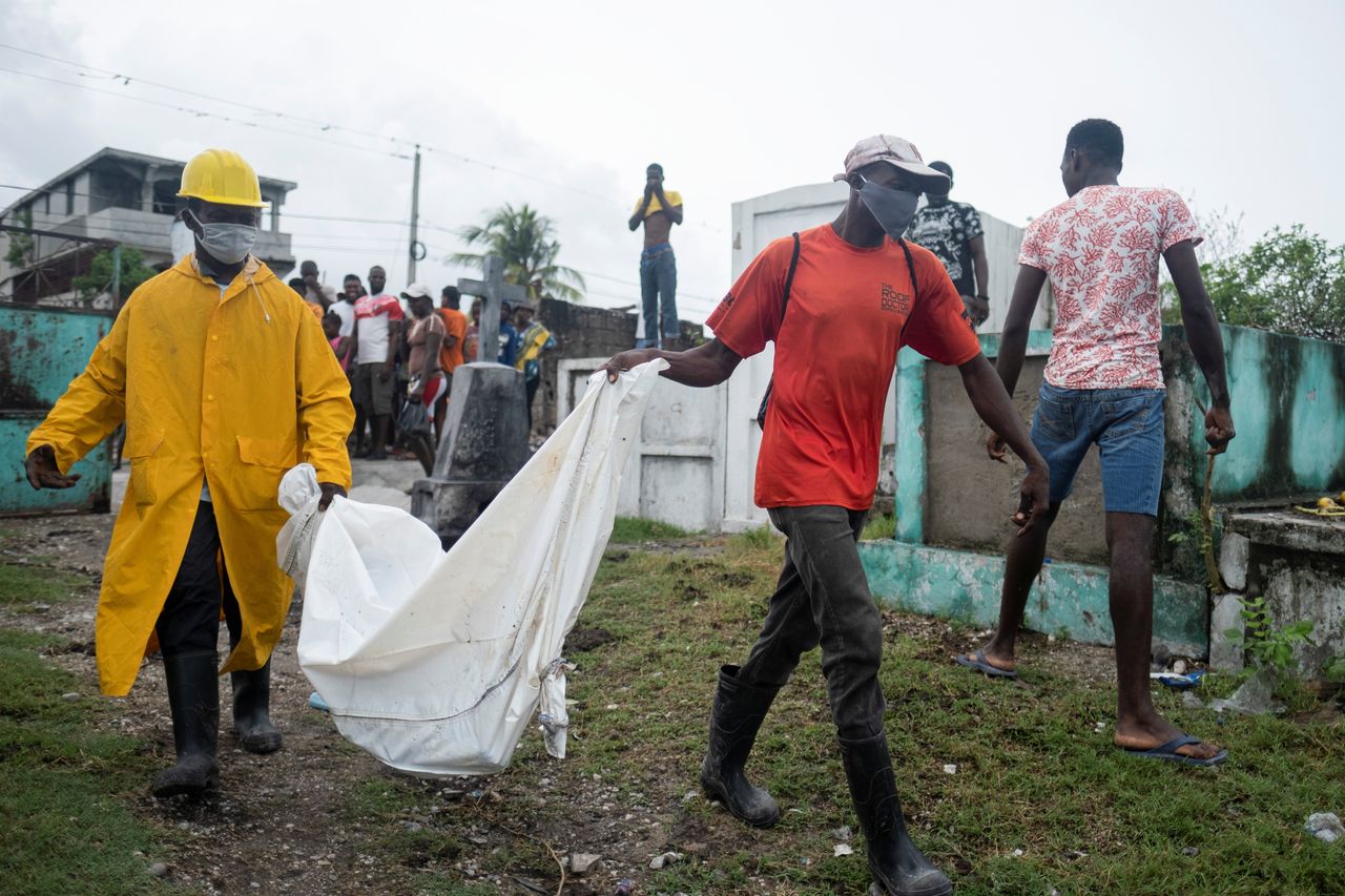 Men in Les Cayes, Haiti carry the body of a victim from Saturday's 7.2 magnitude quake.