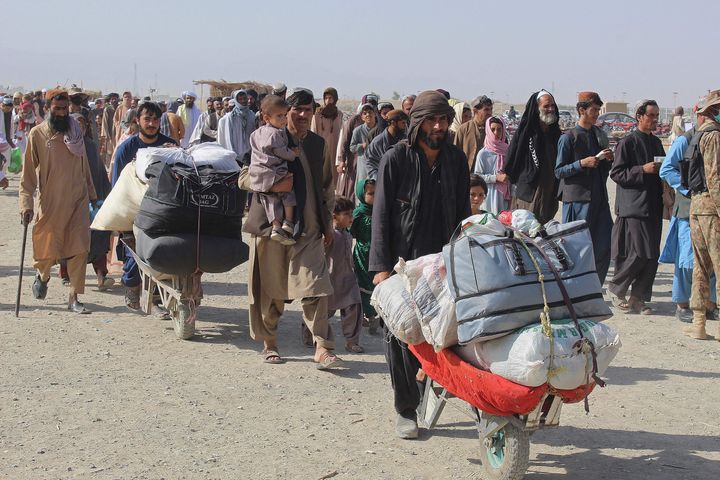 Afghan nationals arrive at the Pakistan-Afghanistan border crossing point in Chaman on August 20, 2021, to return back to Afghanistan