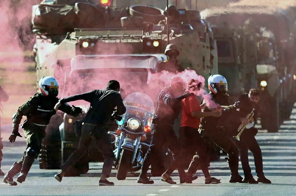 Brazilian military police arrest protesters who tried to block an armed forces parade through Bras&iacute;lia, the country's 