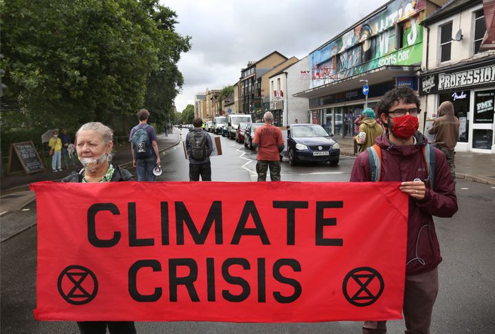 Protesters hold a banner saying climate crisis during the demonstration in Cambridge