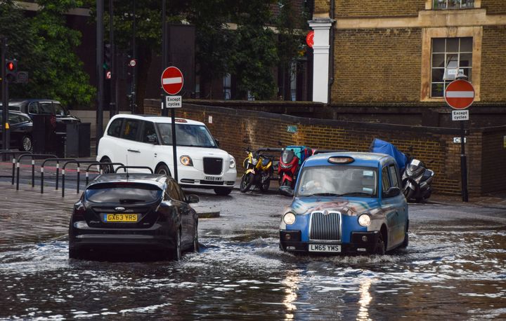 A taxi drives through a flooded Farringdon Lane in central London after a day of heavy rain in the capital in 2021