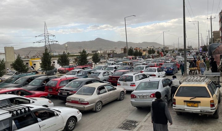 Afghans continue to wait around the Hamid Karzai International Airport as they try to leave the Afghan capital of Kabul on Saturday.