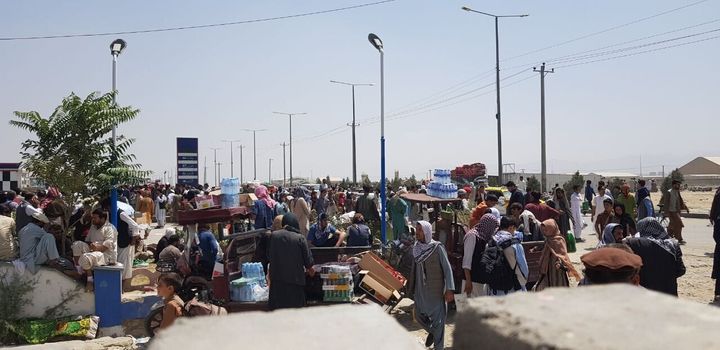 Afghans continue to wait around the Hamid Karzai International Airport as they try to leave the Afghan capital of Kabul on Saturday.