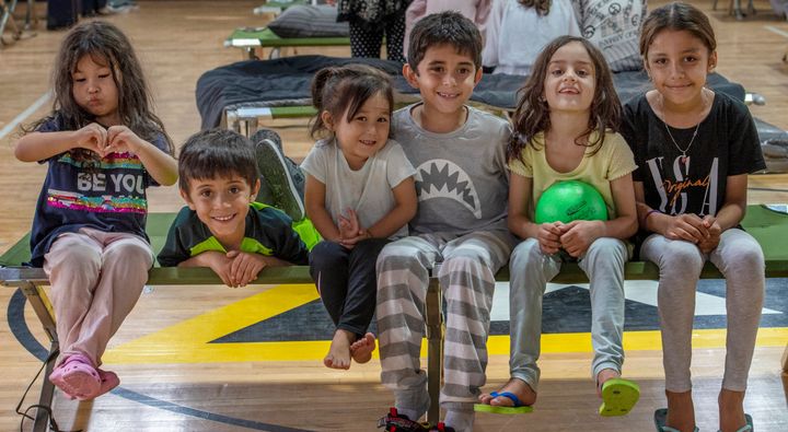 Children pose for a picture in a gym in an undisclosed location in the Middle East region on Aug. 20 after being evacuated onboard a military aircraft from Hamid Karzai International Airport in Kabul, Afghanistan.