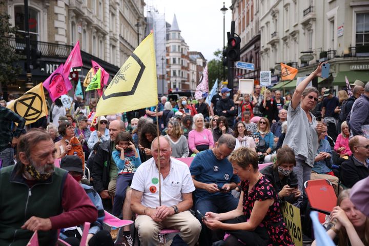 Extinction Rebellion protesters take part in a protest in the Covent Garden area on August 23, 2021