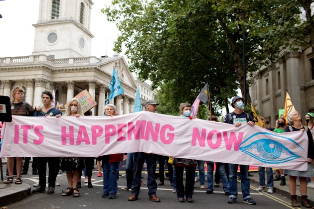 Members of climate change activist movement Extinction Rebellion march along Charing Cross