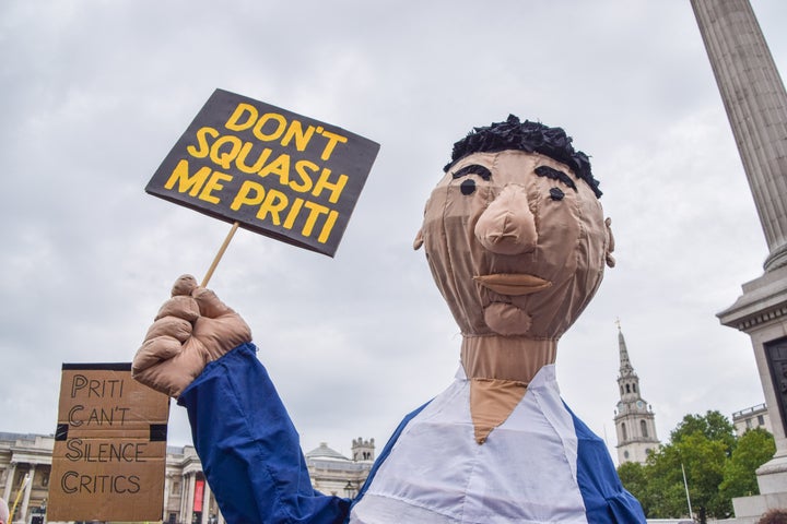 A demonstrator wearing a costume holds a placard which says 'Don't Squash Me Priti (Patel)' during the Kill The Bill protest against the Police, Crime, Sentencing and Courts Bill