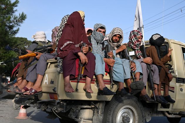 Taliban fighters in a vehicle patrol the streets of Kabul on August 23,