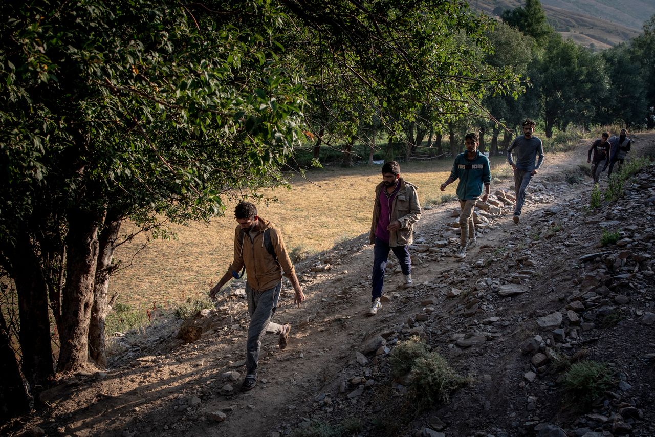 Migrants from Afghanistan walk along a village pathway to reach Tatvan city on July 17, 2021 in Tatvan, Turkey.