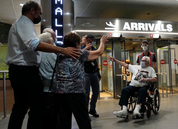 Martin Adler, a 97-year-old retired American soldier, right, reunited with the three children he saved during World War II. T