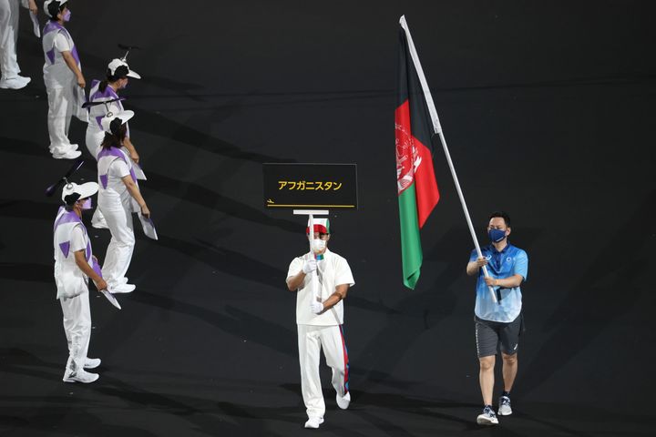 24 August 2021, Japan, Tokio: Paralympics: Opening ceremony at the Olympic Stadium. The flag of Afghanistan is presented by volunteers at the Paralympics. Photo: Karl-Josef Hildenbrand/dpa (Photo by Karl-Josef Hildenbrand/picture alliance via Getty Images)