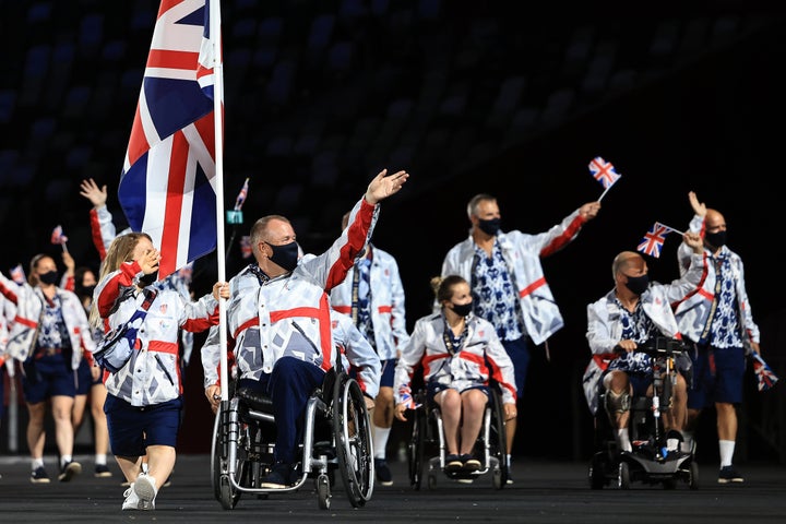 Flag bearers Eleanor Simmonds and John Stubbs of Team Great Britain lead their delegation in the parade of athletes during the opening ceremony of the Tokyo 2020 Paralympic Games.