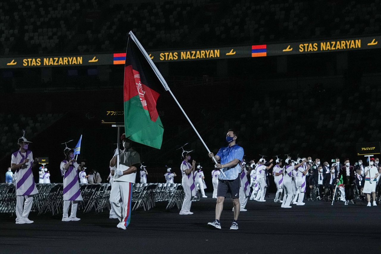 The flag of Afghanistan is carried out at the opening ceremony for the Tokyo 2020 Paralympic Games.