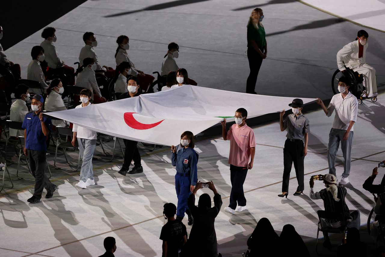The Paralympic flag is brought in during the opening ceremony of the Tokyo 2020 Paralympic Games at the Olympic Stadium.