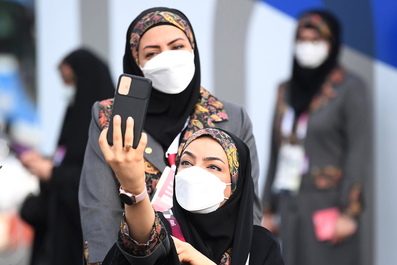 Athlete Samira Eram of Team Iran takes a selfie as she makes way to the opening ceremony.