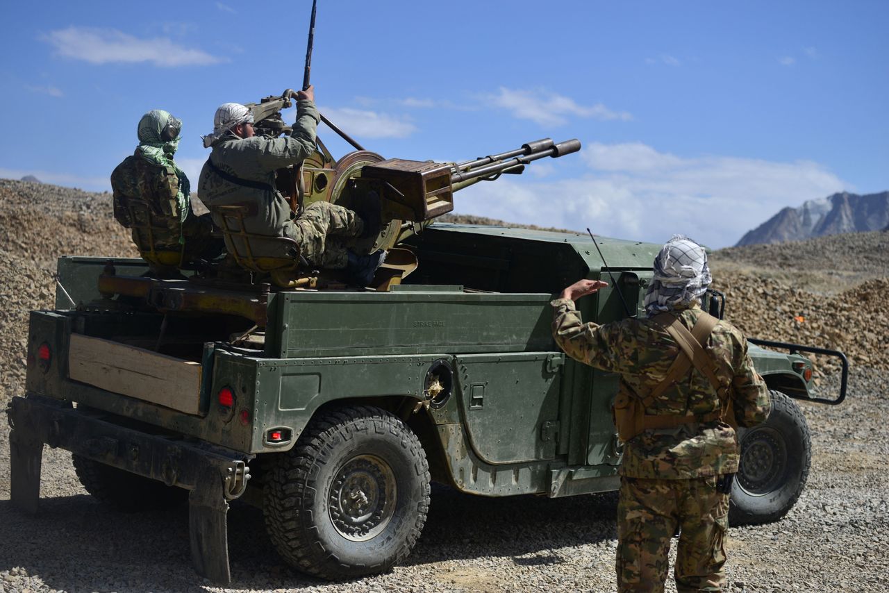 Afghan resistance movement and anti-Taliban uprising forces personnel patrol on an armoured humvee at an outpost in Kotal-e Anjuman of Paryan district in Panjshir province on August 23, 2021