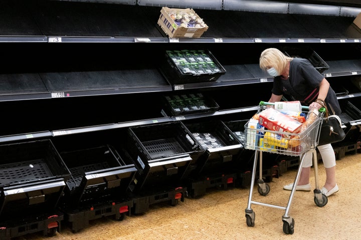 A woman wearing a face mask near empty fruit and veg shelves in an ASDA store on July 23, 2021 in Cardiff, United Kingdom