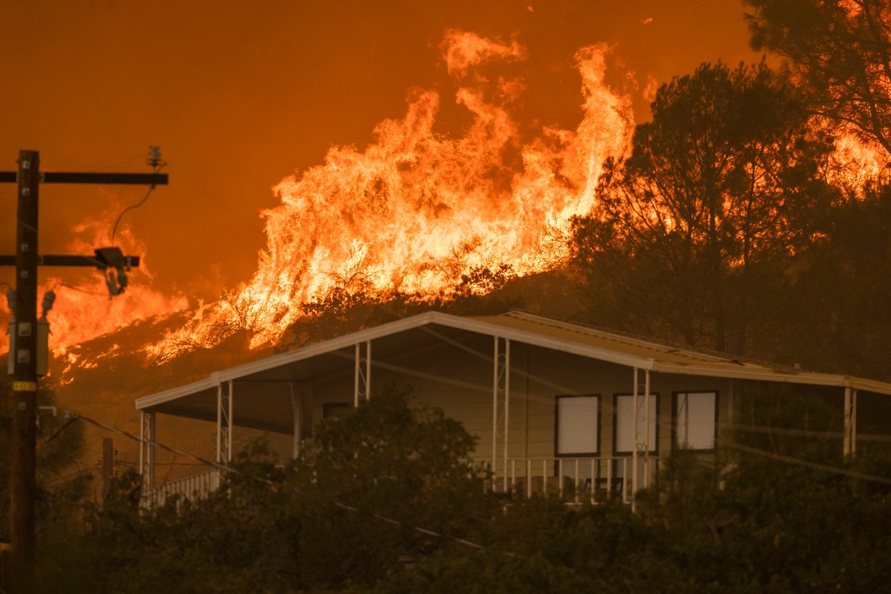 A wildfire approaches homes on Aug. 24 in Wofford Heights, California.