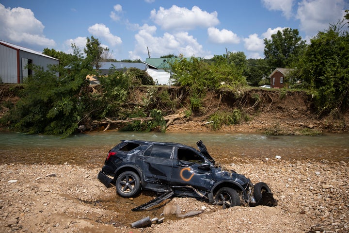 A vehicle destroyed by flooding sits in Trace Creek in Waverly, Tennessee. Heavy rains on Sunday caused flash flooding in the area, killing at least 22 people.