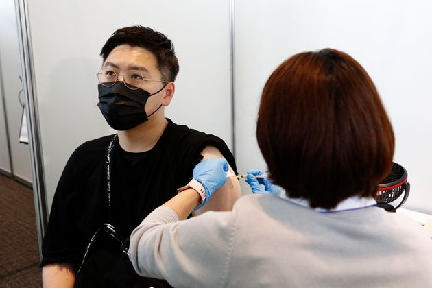TOKYO, JAPAN - JUNE 25: A man receives the Moderna coronavirus vaccine at the Tokyo Metropolitan Government building on June 25, 2021 in Tokyo, Japan. Despite an initially slow start, Japans vaccination drive has increased with around 11 million people now fully vaccinated. The country has also pledged to give one million vaccines each to Taiwan and Vietnam. (Photo by Rodrigo Reyes Marin - Pool/Getty Images)