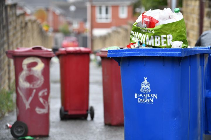 A 'Blackburn with Darwen Borough Council" logo is pictured on an overflowing wheelie bin on July 15, 2020