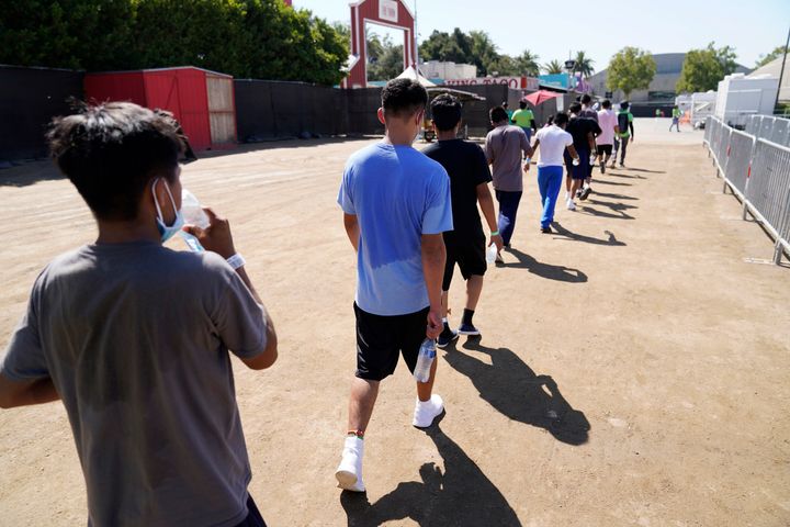In this July 2, 2021, file photo, children walk together after a game of soccer at an emergency shelter for migrant children in Pomona, Calif. 
