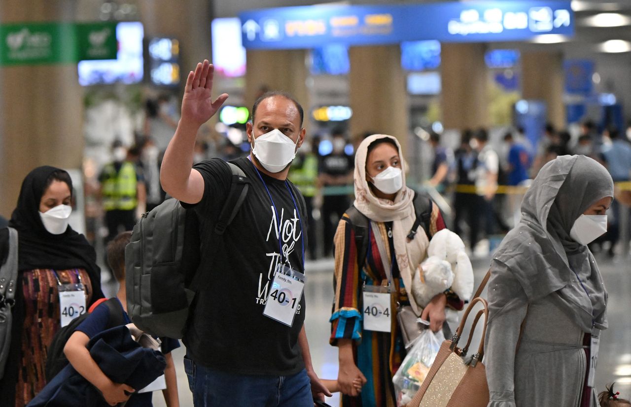 Afghan evacuees arrive at Incheon International Airport outside Seoul on August 26, 2021, following their departure from Kabul via Pakistan