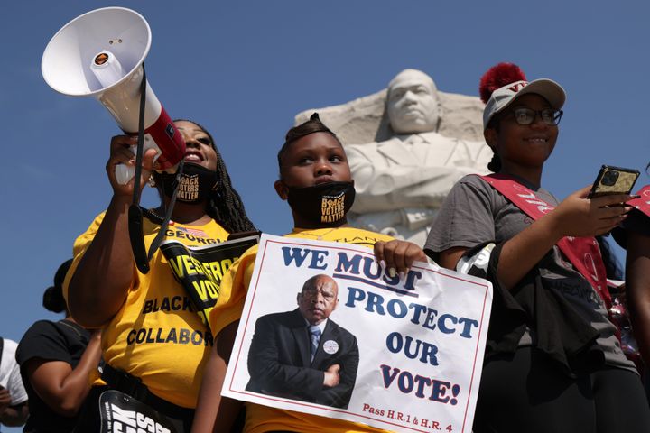 Protesters call for voting rights protections at the Martin Luther King Jr. Memorial in Washington, D.C., in early August. Larger demonstrations will be held at the nation's capital and other cities on Saturday.