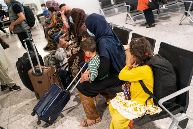 Refugees from Afghanistan wait to be processed after arriving on an evacuation flight at Heathrow Airport...