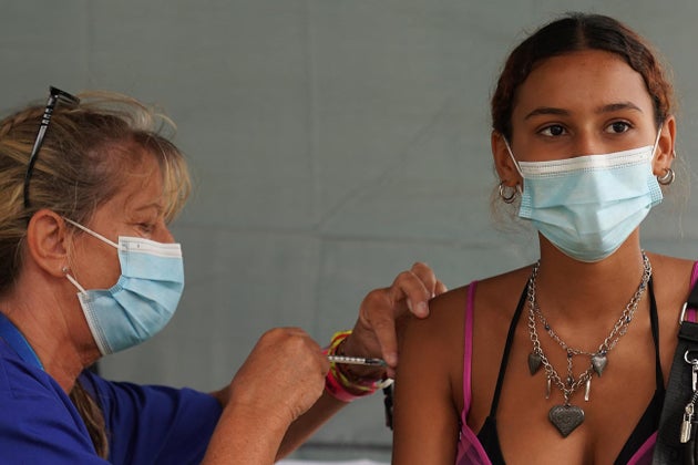 A festival-goer gets an injection at a walk-in Covid-19 vaccination clinic at the Reading Festival on...