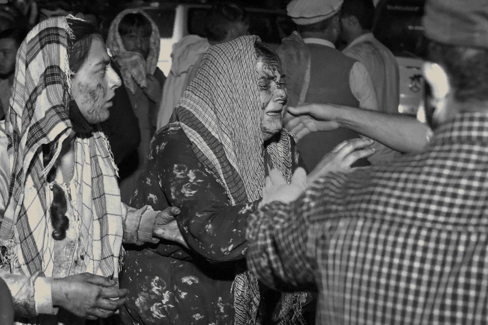 Wounded women arrive at a hospital for treatment after a deadly blast outside the airport in Kabul on Aug. 26.