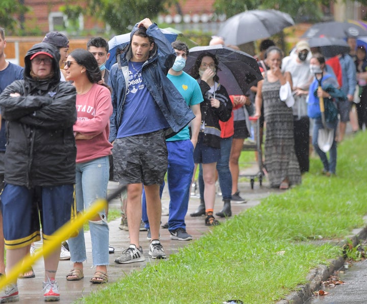 People stand in line to pick up sandbags at a city run sandbag distribution location at the Dryades YMCA in anticipation of H