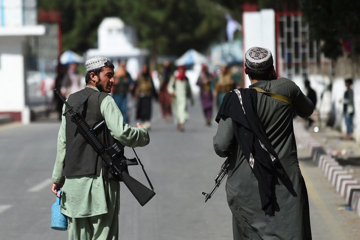 Taliban fighters walk at the main entrance gate of Kabul airport in Kabul on August 28, 2021, following the Taliban stunning military takeover of Afghanistan. (Photo by WAKIL KOHSAR / AFP) (Photo by WAKIL KOHSAR/AFP via Getty Images)