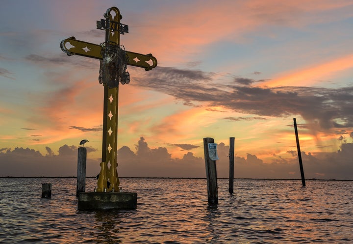 Dawn breaks over the Katrina memorial at Shell Beach on the 16th anniversary of Hurricane Katrina as Hurricane Ida approaches the Louisiana coast in St. Bernard, La. Saturday, Aug. 28, 2021.