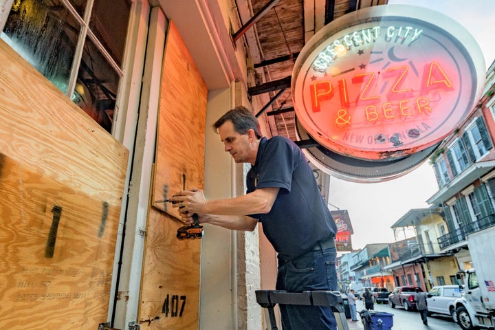 Michael Richard of Creole Cuisine Restaurant Concepts boards up Crescent City Pizza on Bourbon Street in the French Quarter before landfall of Hurricane Ida in New Orleans, Saturday, Aug. 28, 2021.