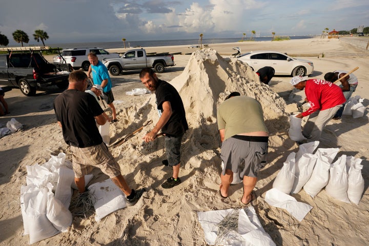 Local residents fill sand bags as they prepare for the expected arrival of Hurricane Ida Saturday, Aug. 28, 2021, in Gulfport, Miss.