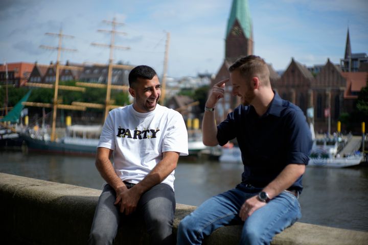 U.S. Army veteran Spencer Sullivan, right, and Abdulhaq Sodais, who served as a translator in Afghanistan, joke during an interview in Bremen, Germany, on Aug. 14.
