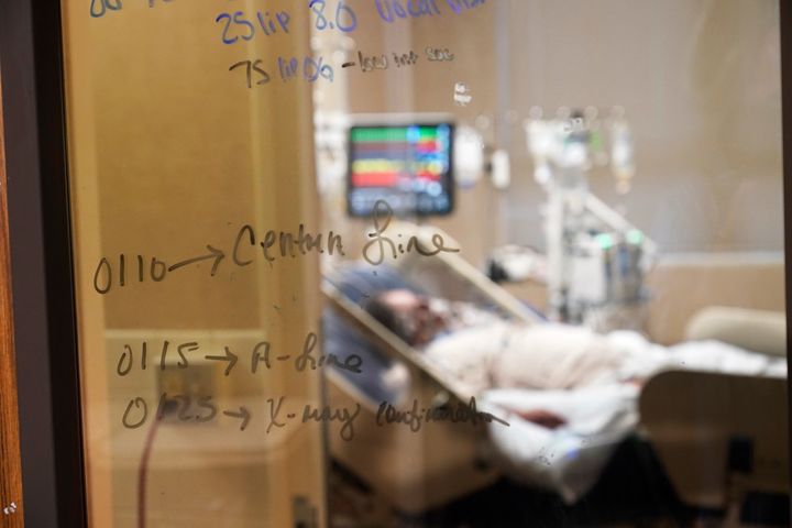 Medical notations are written on a window of a COVID-19 patient's room in an intensive care unit at the Willis-Knighton Medical Center in Shreveport, La., on Aug. 18. 