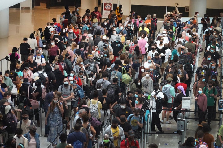 People stand in line to get through the TSA security checkpoint at Louis Armstrong New Orleans International Airport on Saturday in New Orleans, Louisiana.