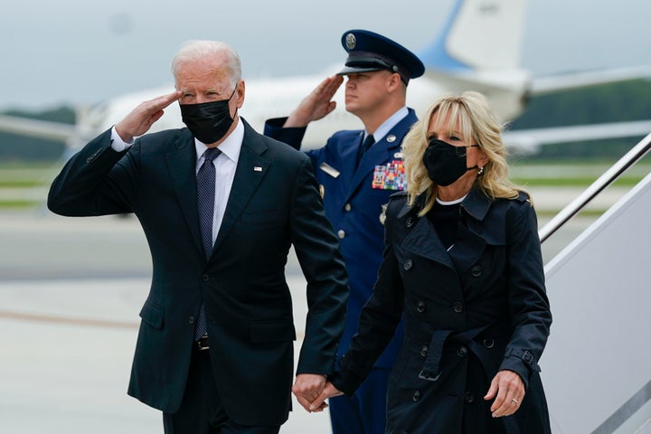 President Joe Biden returns a salute as he and first lady Jill Biden arrive at Dover Air Force Base in Delaware on Sunday where they honored and mourned the 13 U.S. troops killed in a suicide attack near the Kabul airport.