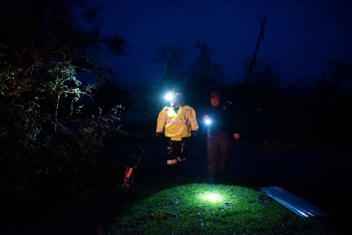 Montegut and Bourg firefighters cut through trees on the road in Bourg, Louisiana as Hurricane Ida passes on August 29, 2021.