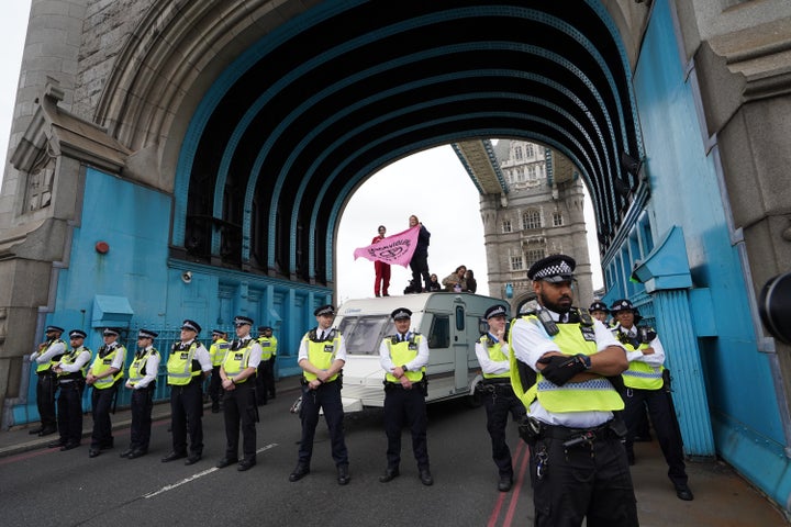 Police by a caravan on Tower Bridge, central London after members of Extinction Rebellion blocked the road.