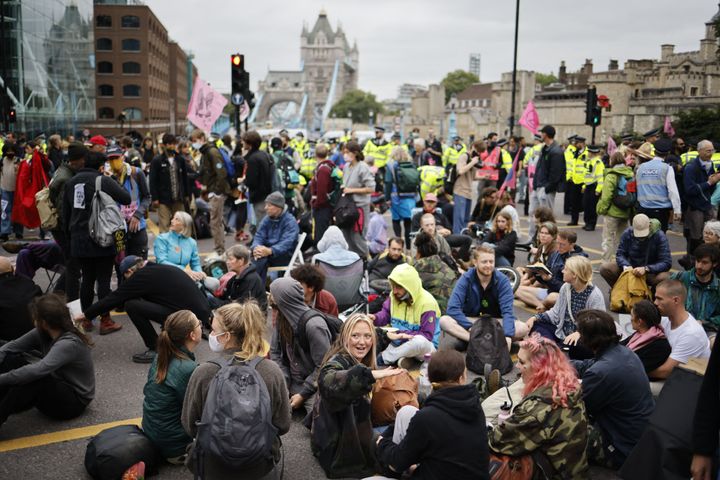 Climate activists from the Extinction Rebellion group block the road leading to Tower Bridge in central London.