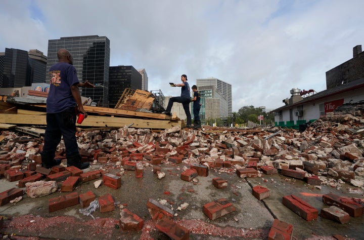 New Orleans Firefighters assess damage as they look through debris after a building collapsed from the effects of Hurricane Ida on Monday.