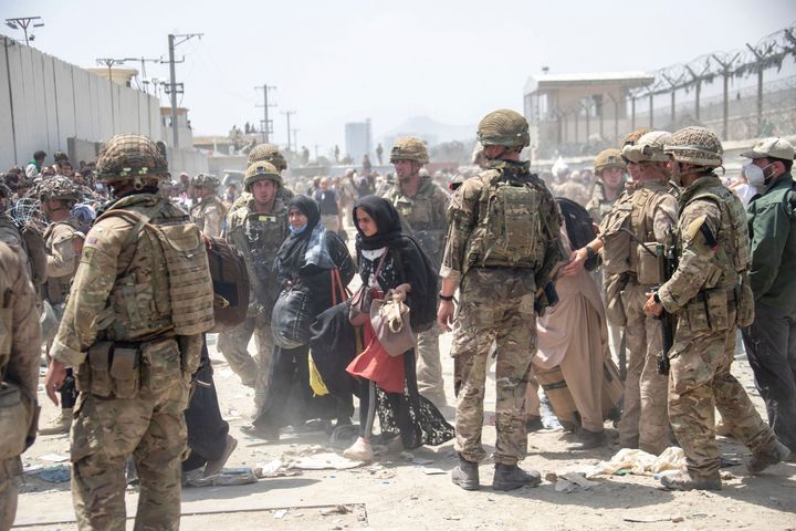 Members of the British and US military engage in the evacuation of people out of Kabul, Afghanistan.