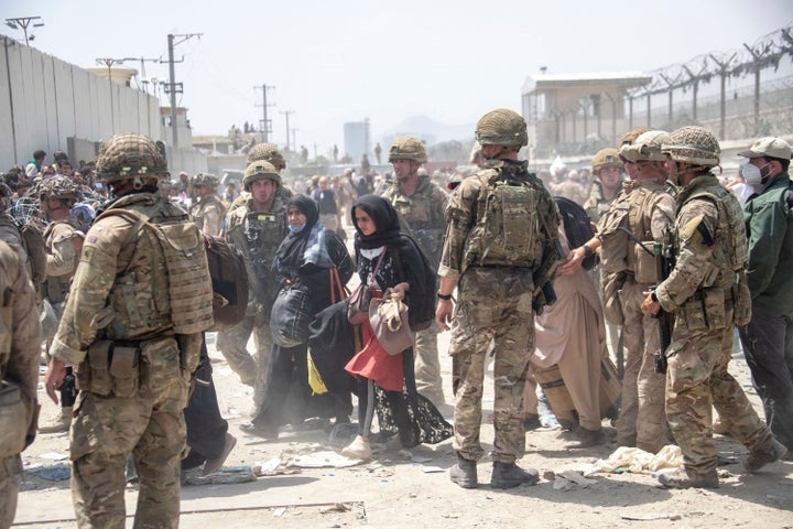 Members of the British and US military engage in the evacuation of people out of Kabul, Afghanistan.